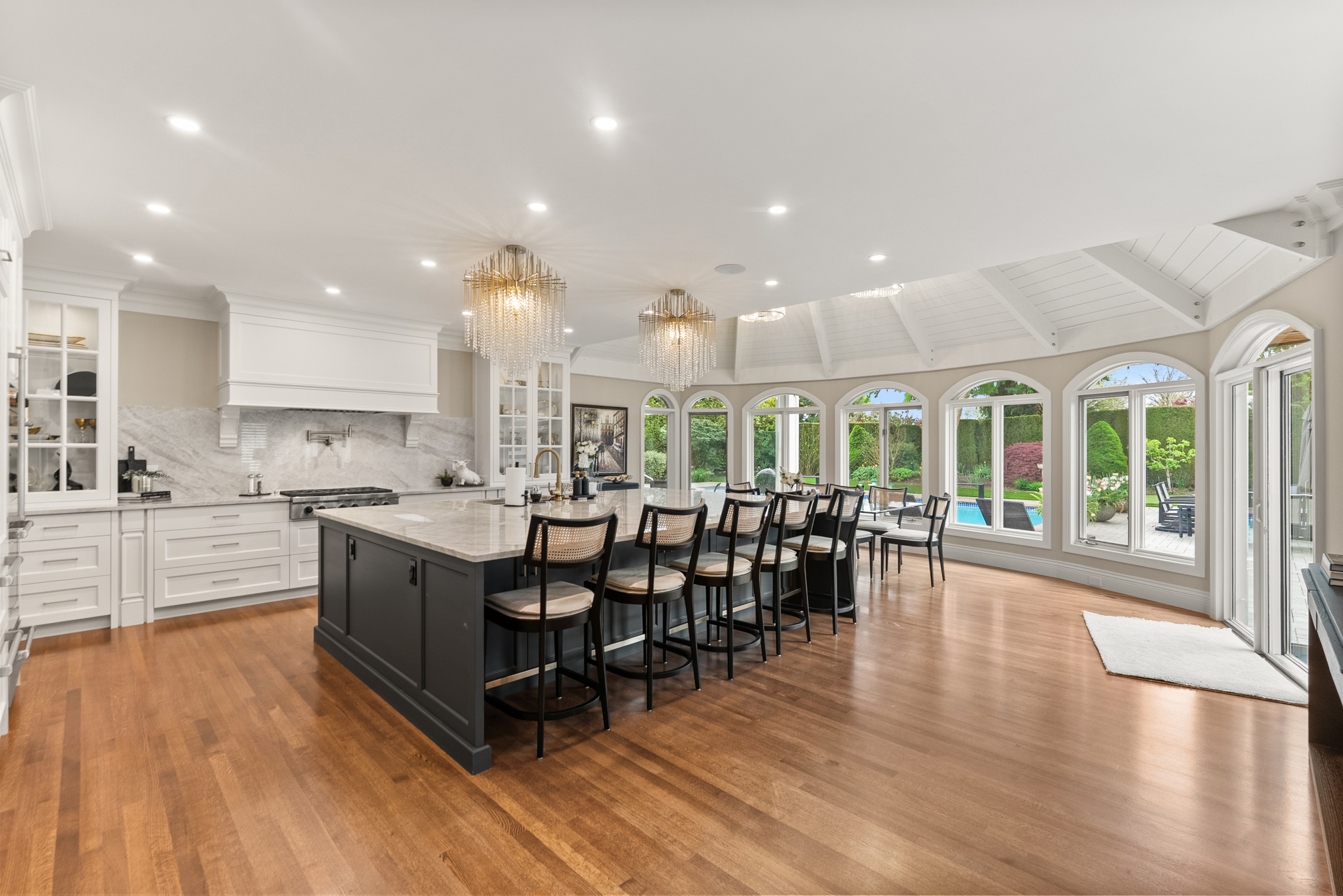 Renovated kitchen with stone island and poolside windows